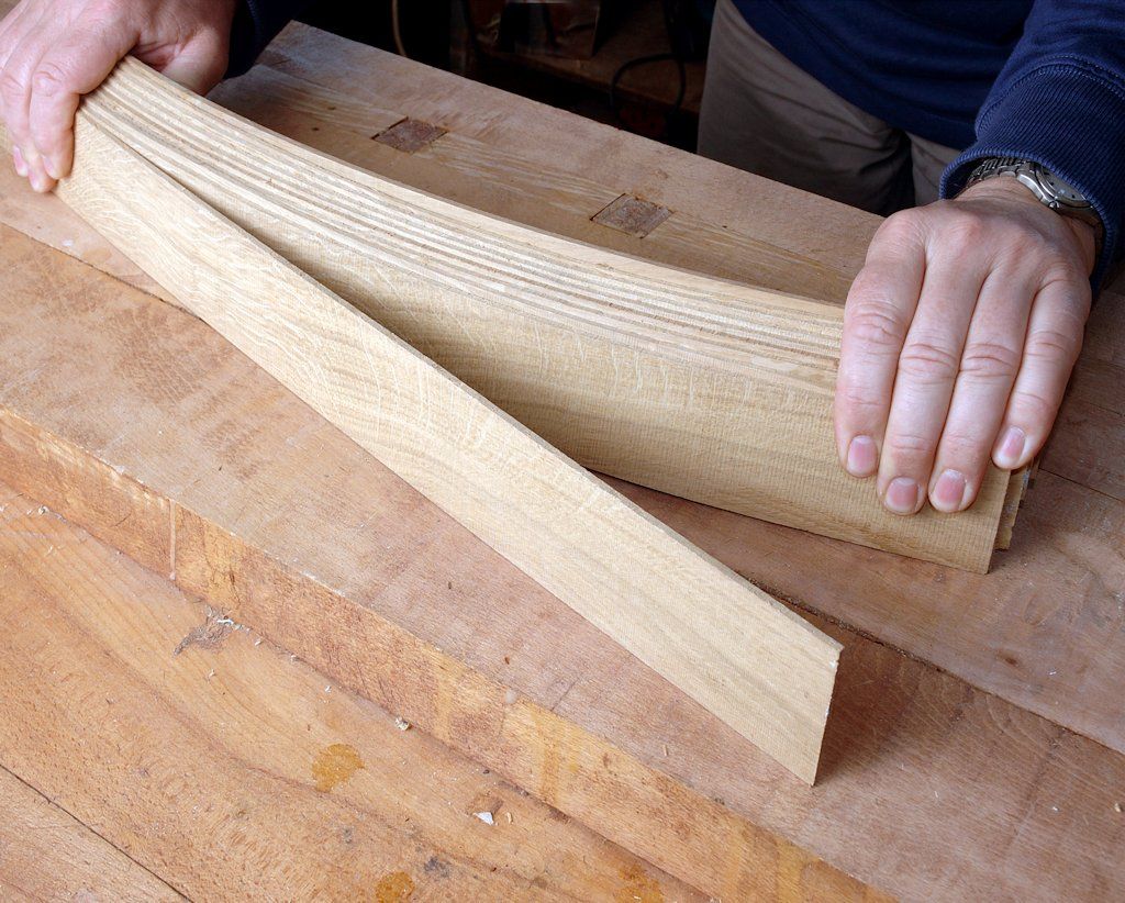 John Bullar rips a solid billet of oak on the bandsaw into strips thin enough to bend in a shallow curve with moderate hand pressure